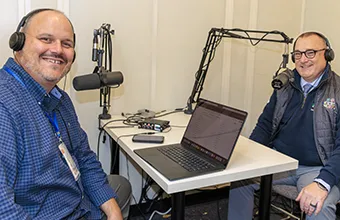 Pat Stoetzer, left, and Michael Duffy record a weekly podcast, ‘The Score and More’, to showcase students, coaches and teams.