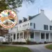 Large white historic house with a wraparound porch on a curved driveway, autumn trees, and an overlaid circular US 250 commemorative seal.