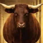 A large brown bull stands in a barn aisle, flanked by cows, goats, and sheep peering from stalls.
